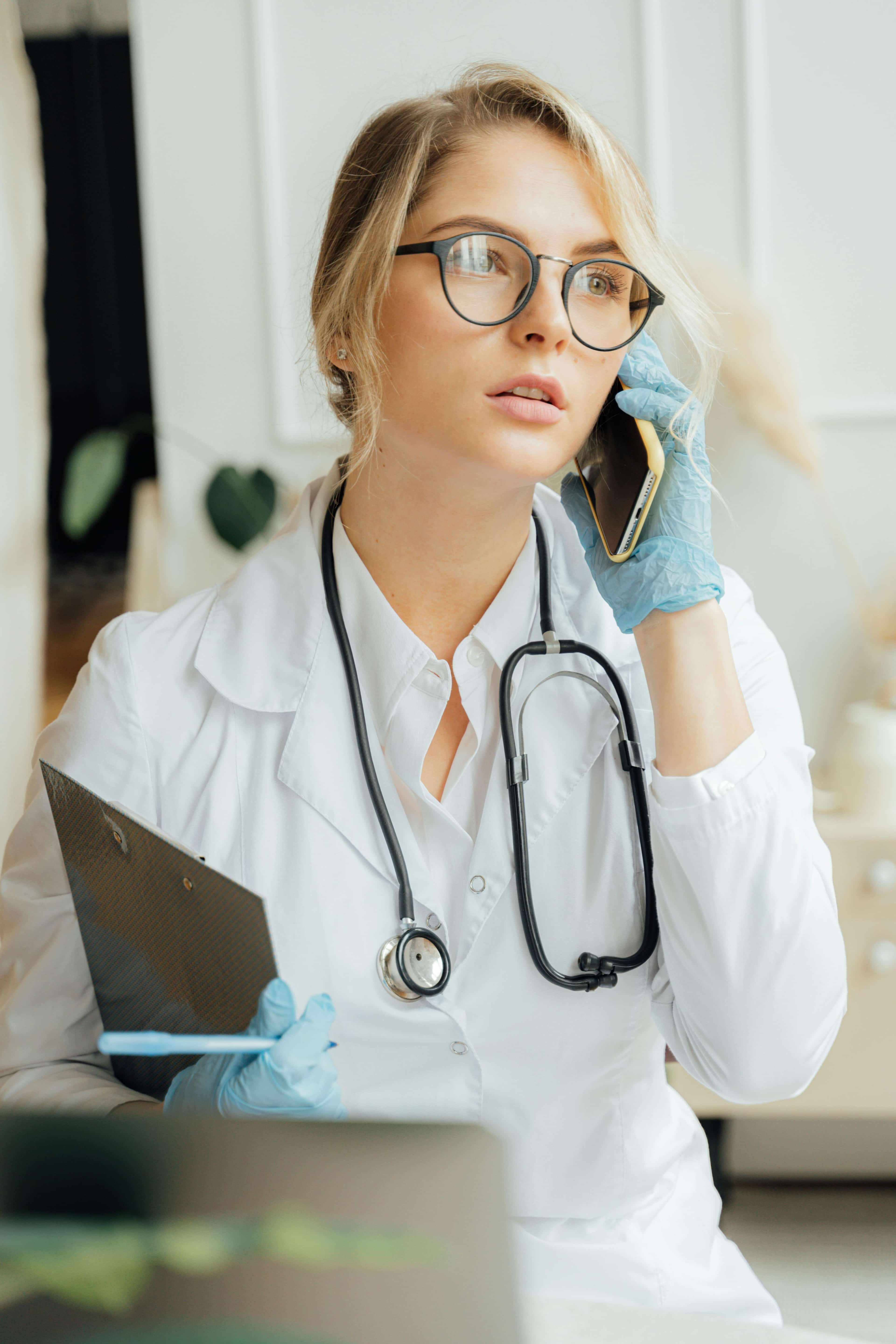 Clinician on the phone, representing sponsor-side after-hours coverage for clinical trials.