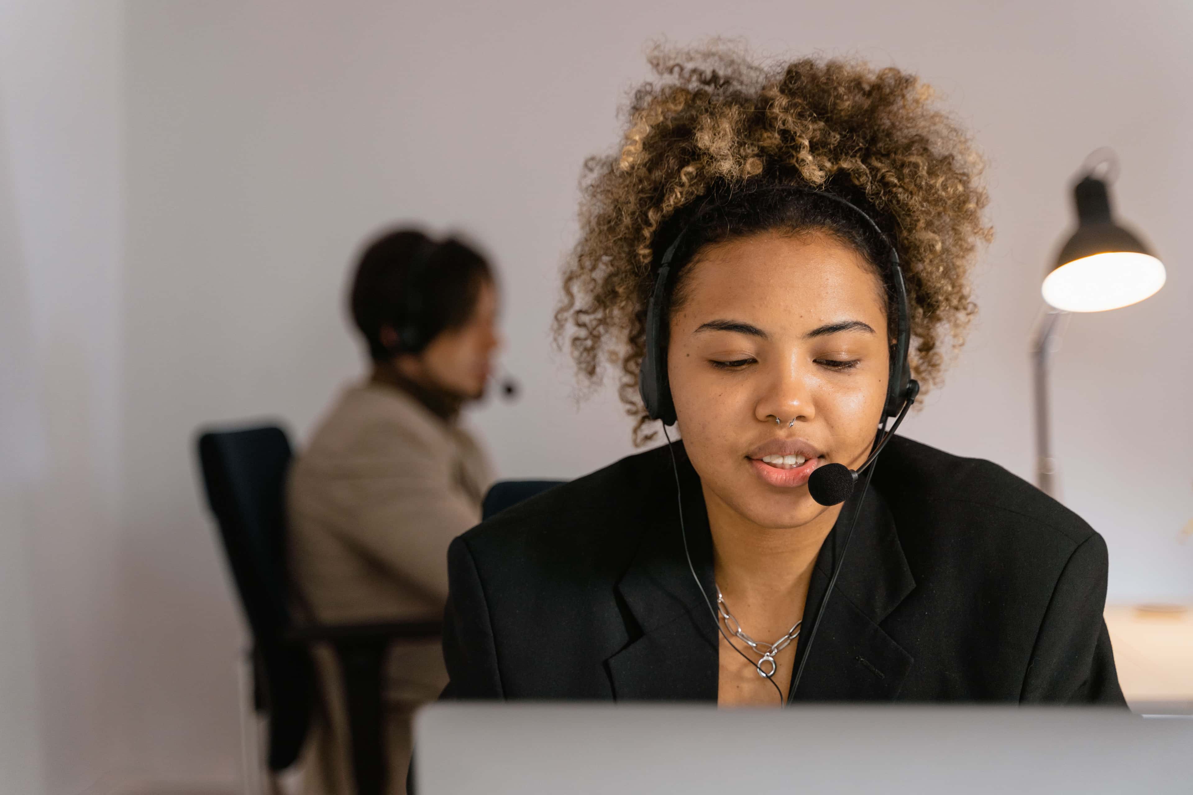Female customer support agent in an office wearing a headset for effective communication