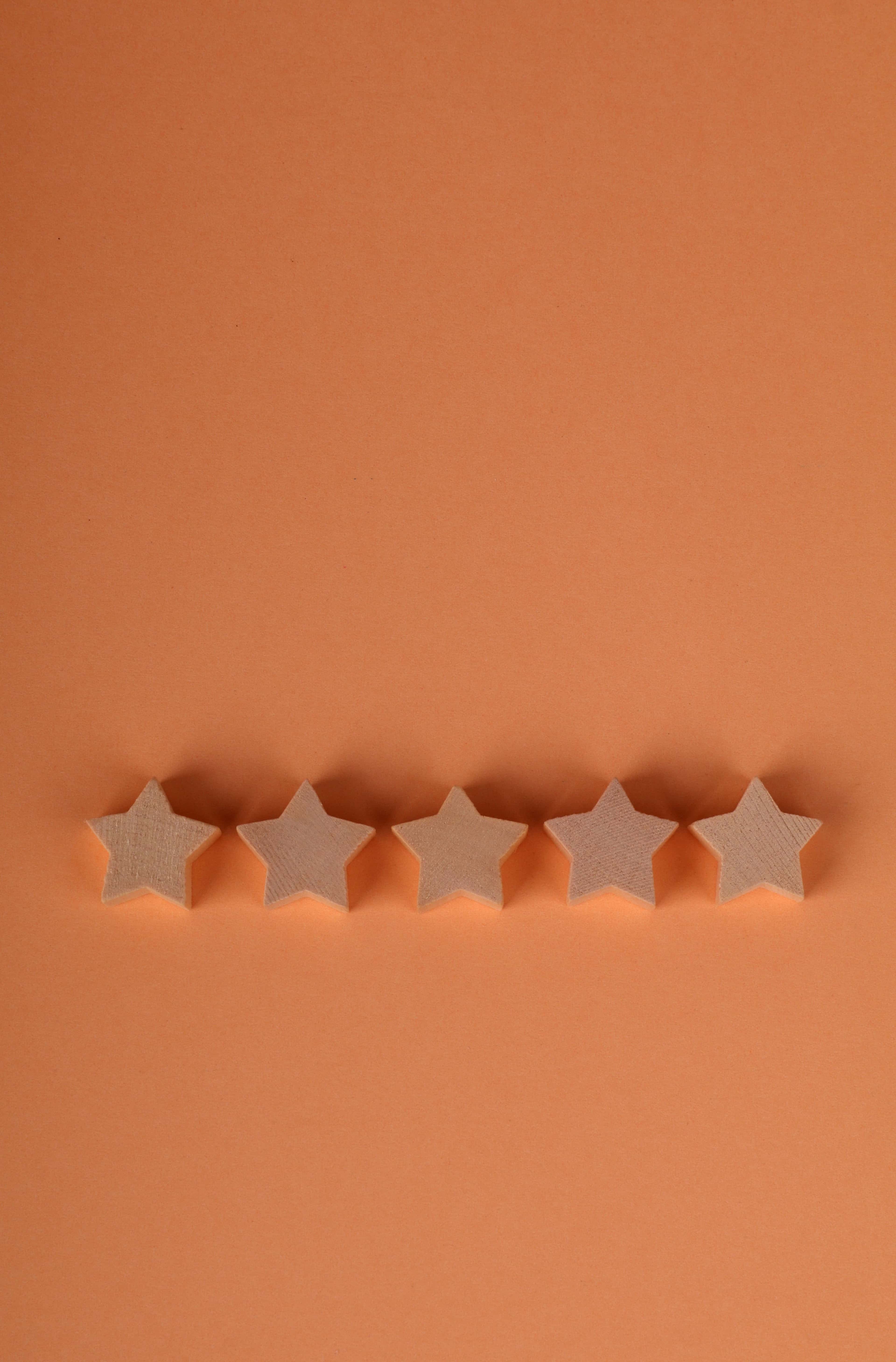 Simple five-star rating on an orange background, showing quality or achievement