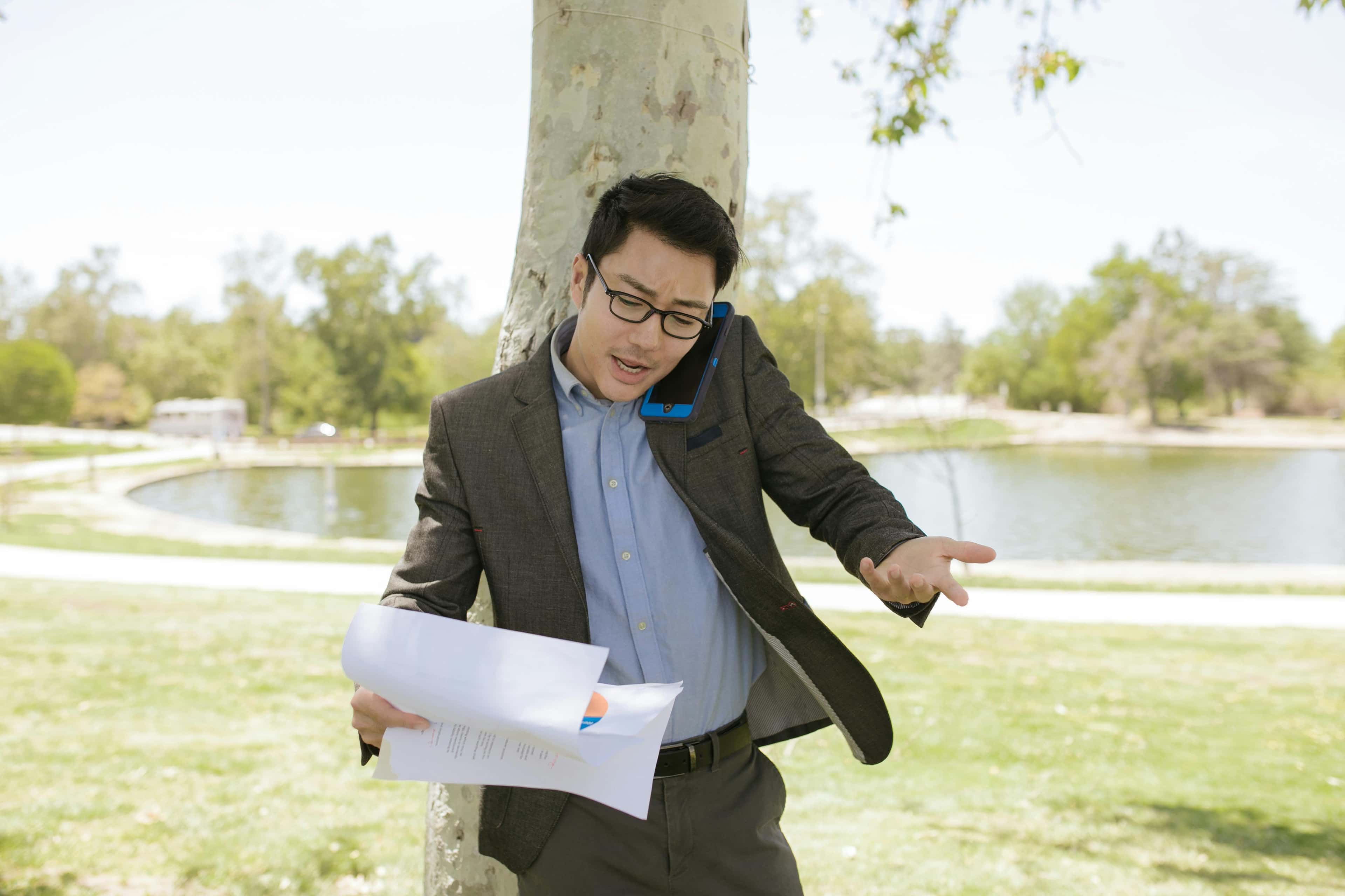 Person reviewing paperwork while talking through hotline audit results